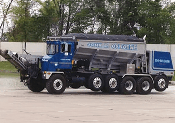 A Large Blue Truck With a Large Trailer